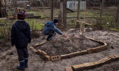 Little Ukrainian Brothers Place Food On Mom’s Grave After She Starved To Death